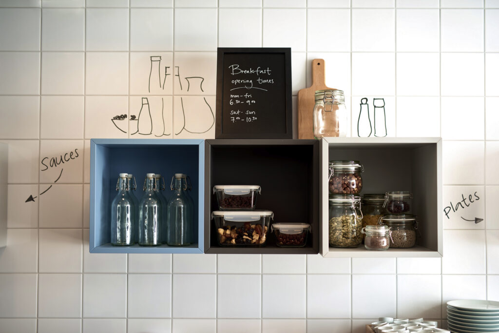 Shelf with breakfast in glass jars.