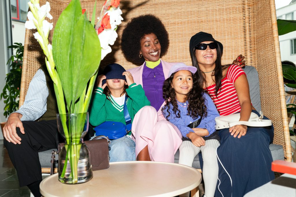 Family of five gathered in a sofa in the hotel lobby.