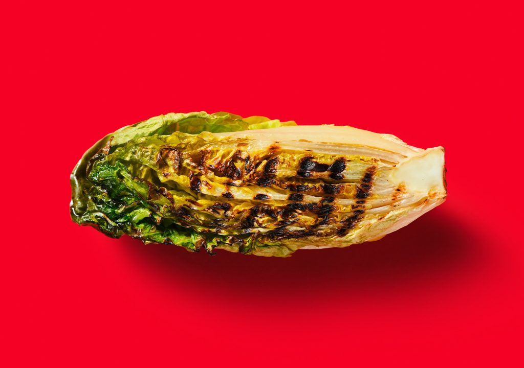 Barbecued cabbage on a red background.