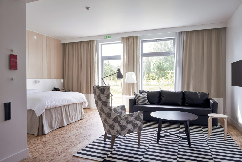 Accessible grand lit room with extra floor space and separate entry.